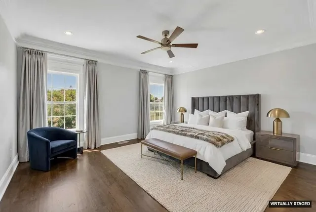 a spacious bedroom with a bed a couch and a window