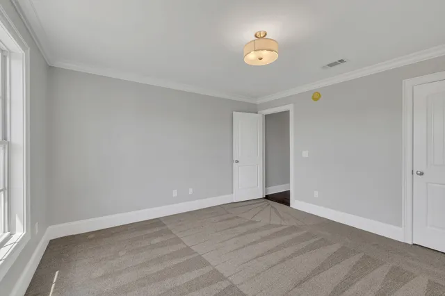 a large bedroom with a large bed and a dresser