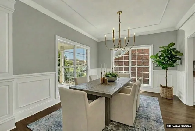 a dining room with table chairs and windows