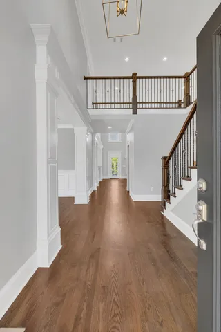 a view of staircase with railing and white walls