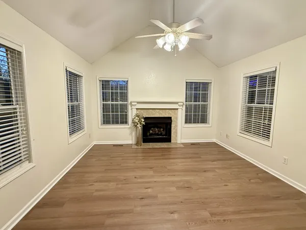 a view of empty room with wooden floor