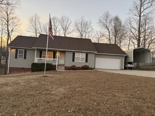 a house that has a tree in front of it