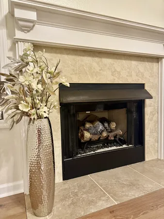 a black and white photo of a fireplace