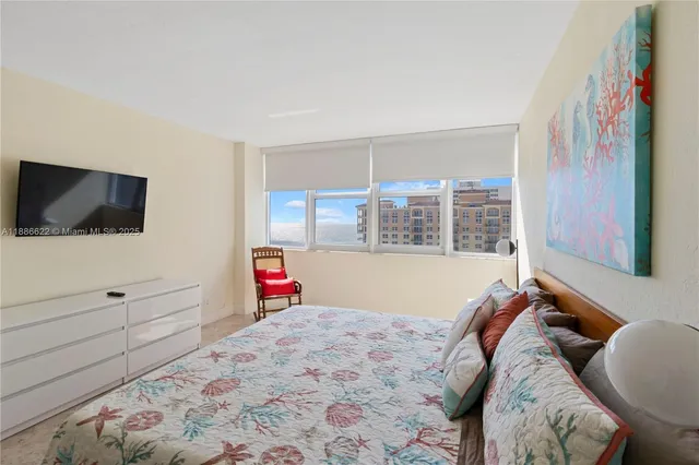 a bed room with a bed and a television