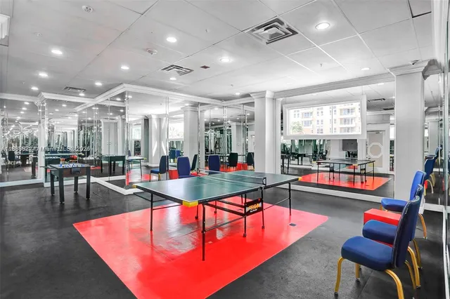 a room with lots of furniture and view of kitchen