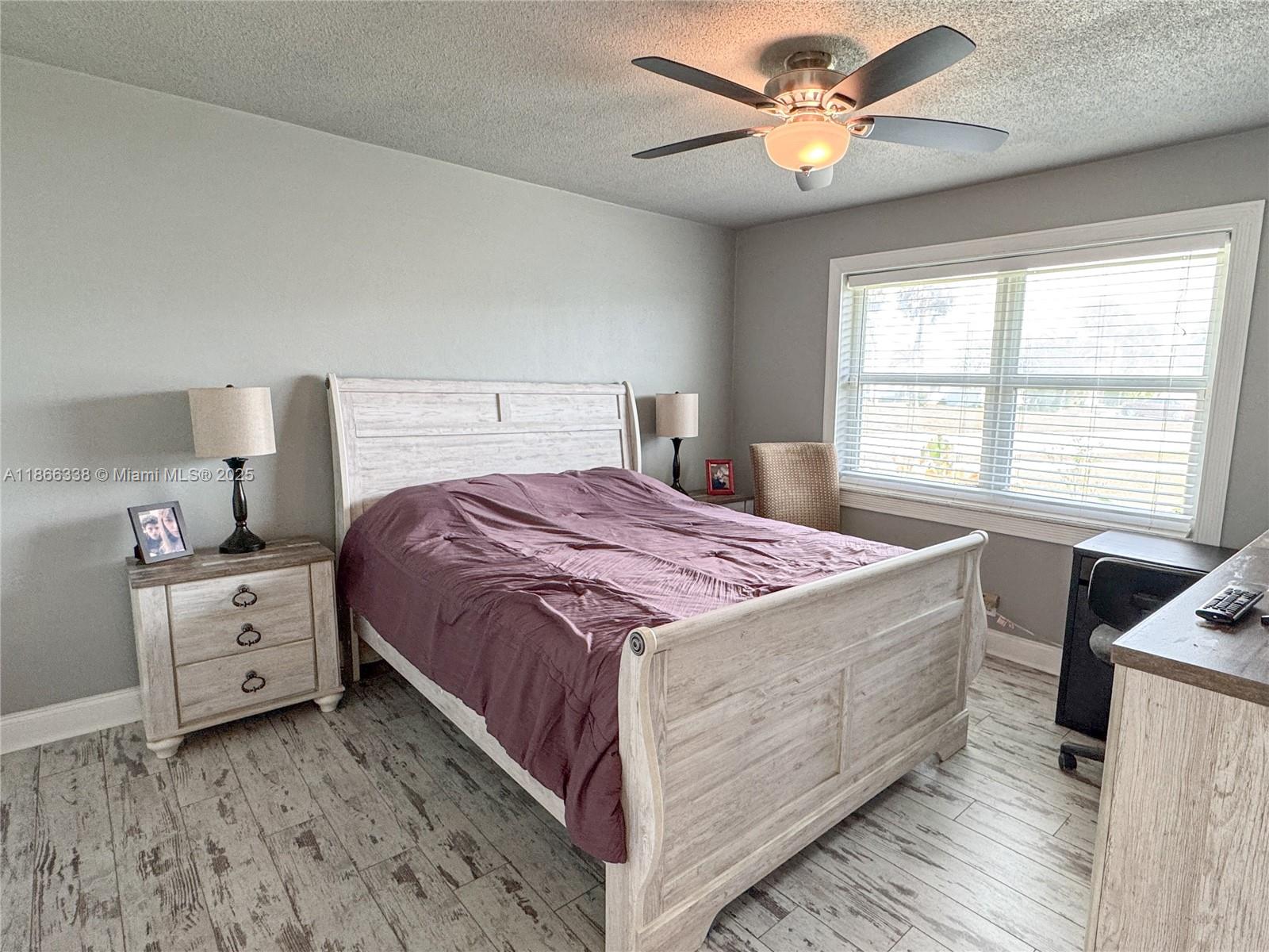 161 Northwest 27th Court Pompano Beach, FL 33064 - Photo 14 of 33 a bedroom with a bed and a ceiling fan