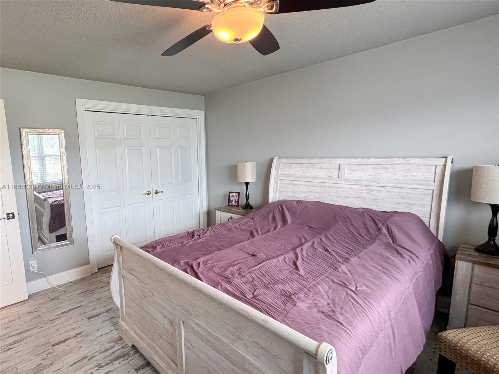 161 Northwest 27th Court Pompano Beach, FL 33064 - Photo 15 of 33 a bedroom with a large bed and wooden floor