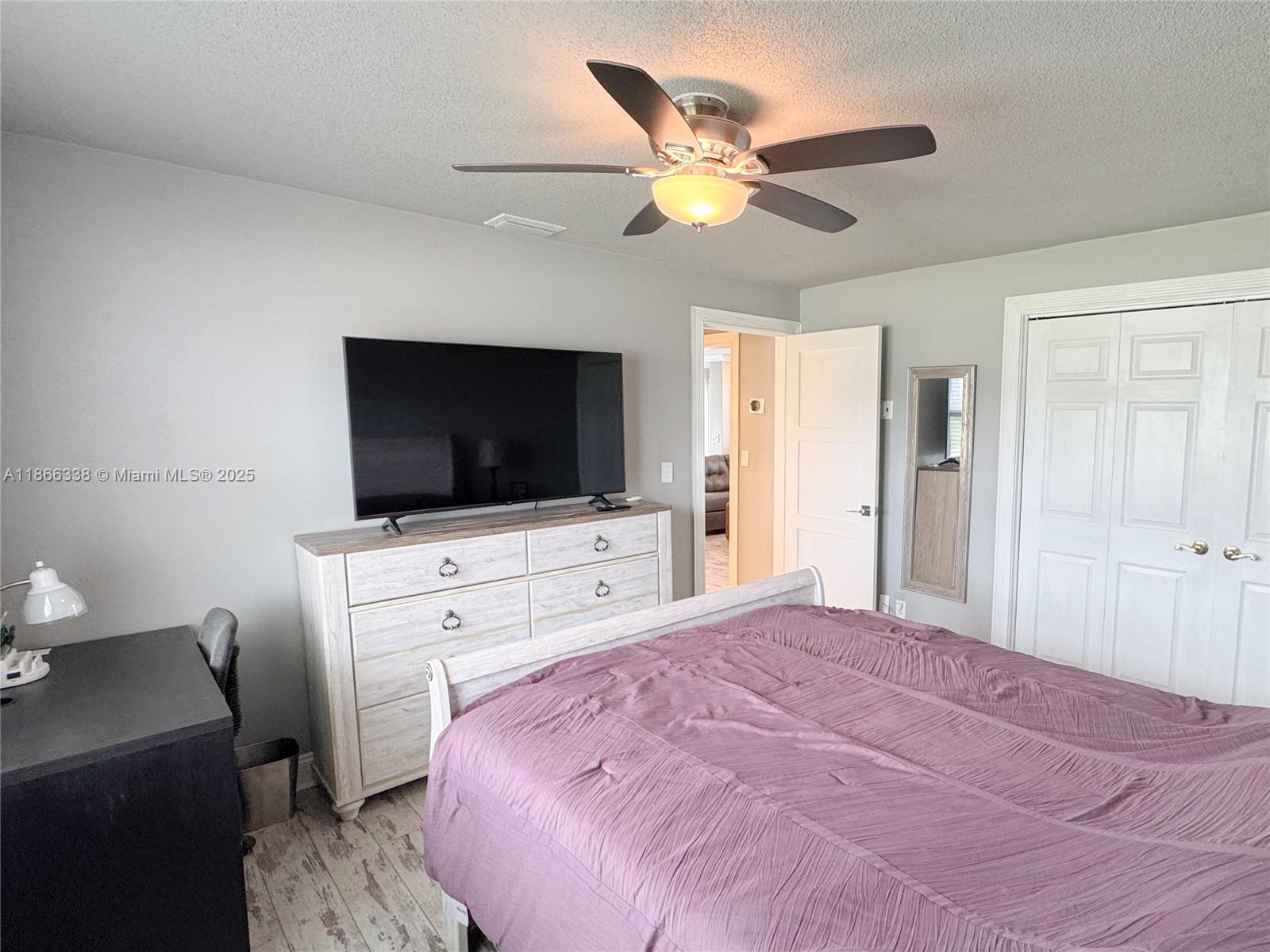 161 Northwest 27th Court Pompano Beach, FL 33064 - Photo 16 of 33 a bedroom with a bed and a flat screen tv