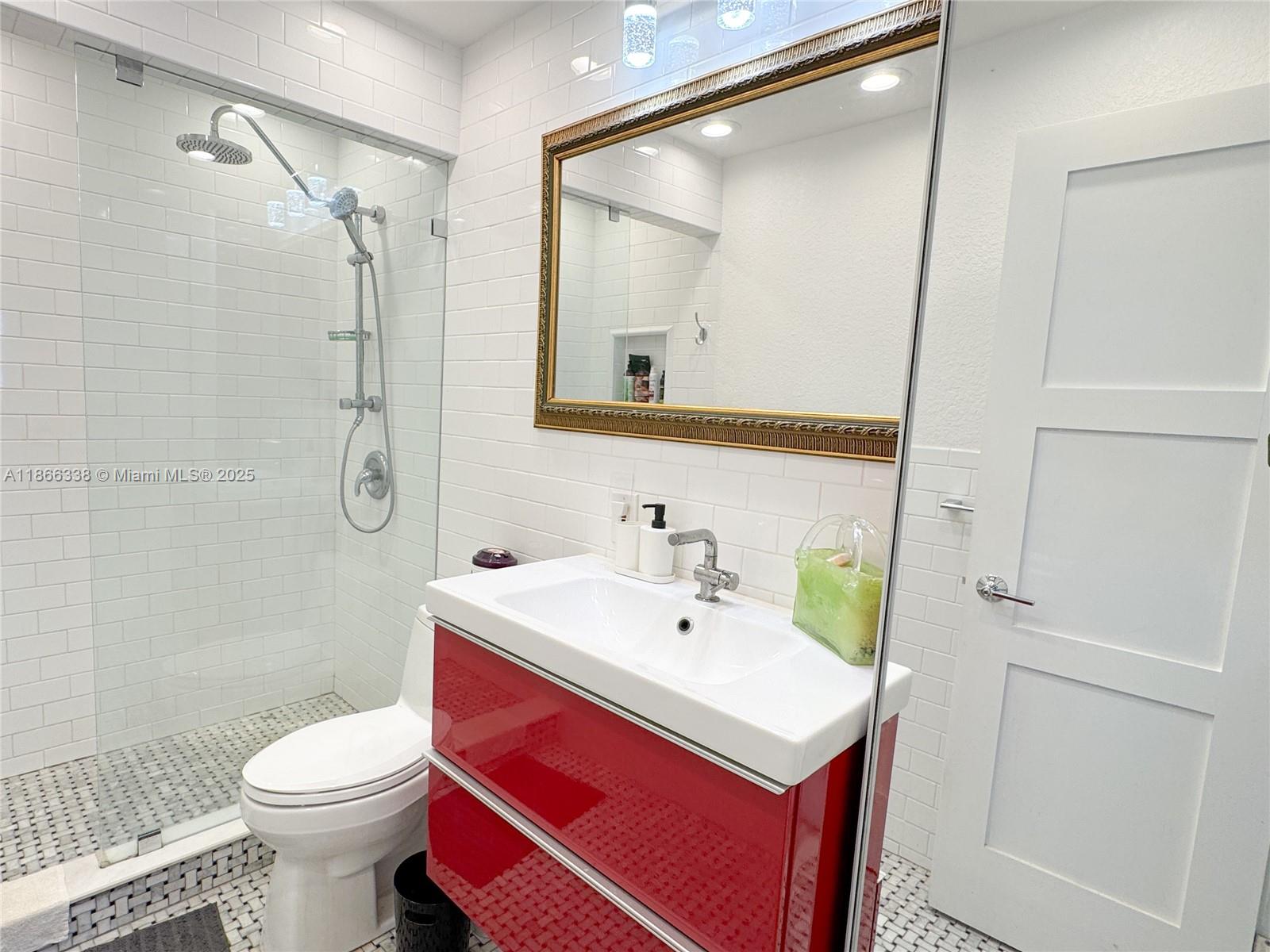 161 Northwest 27th Court Pompano Beach, FL 33064 - Photo 18 of 33 a bathroom with a sink toilet and shower