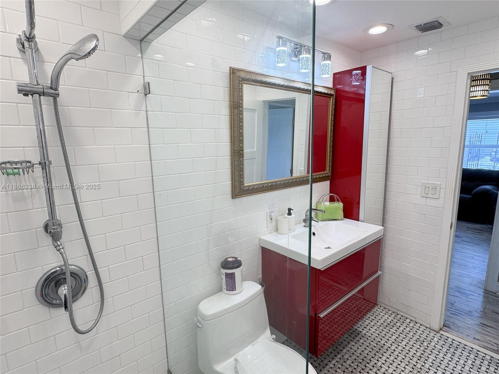 161 Northwest 27th Court Pompano Beach, FL 33064 - Photo 19 of 33 a bathroom with a sink and a mirror