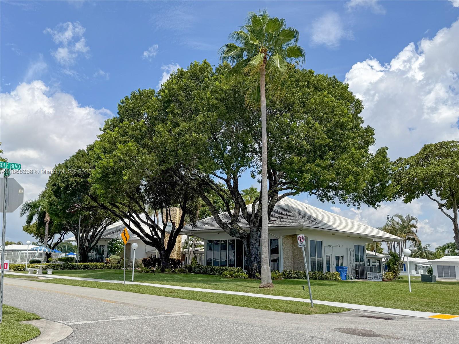 161 Northwest 27th Court Pompano Beach, FL 33064 - Photo 24 of 33 a view of a big house in a big yard with large trees