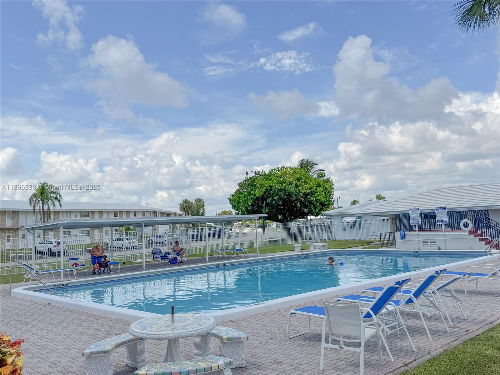 161 Northwest 27th Court Pompano Beach, FL 33064 - Photo 27 of 33 a view of swimming pool with outdoor seating and plants