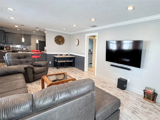 a living room with furniture window and wooden floor
