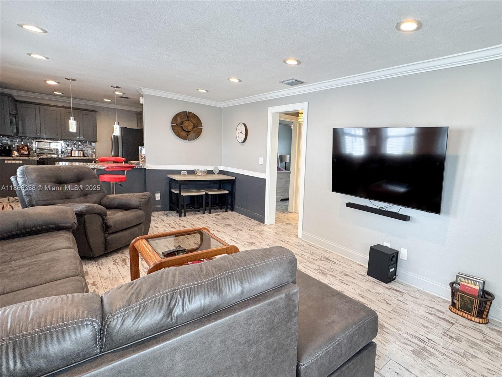 161 Northwest 27th Court Pompano Beach, FL 33064 - Photo 4 of 33 a living room with furniture and a flat screen tv