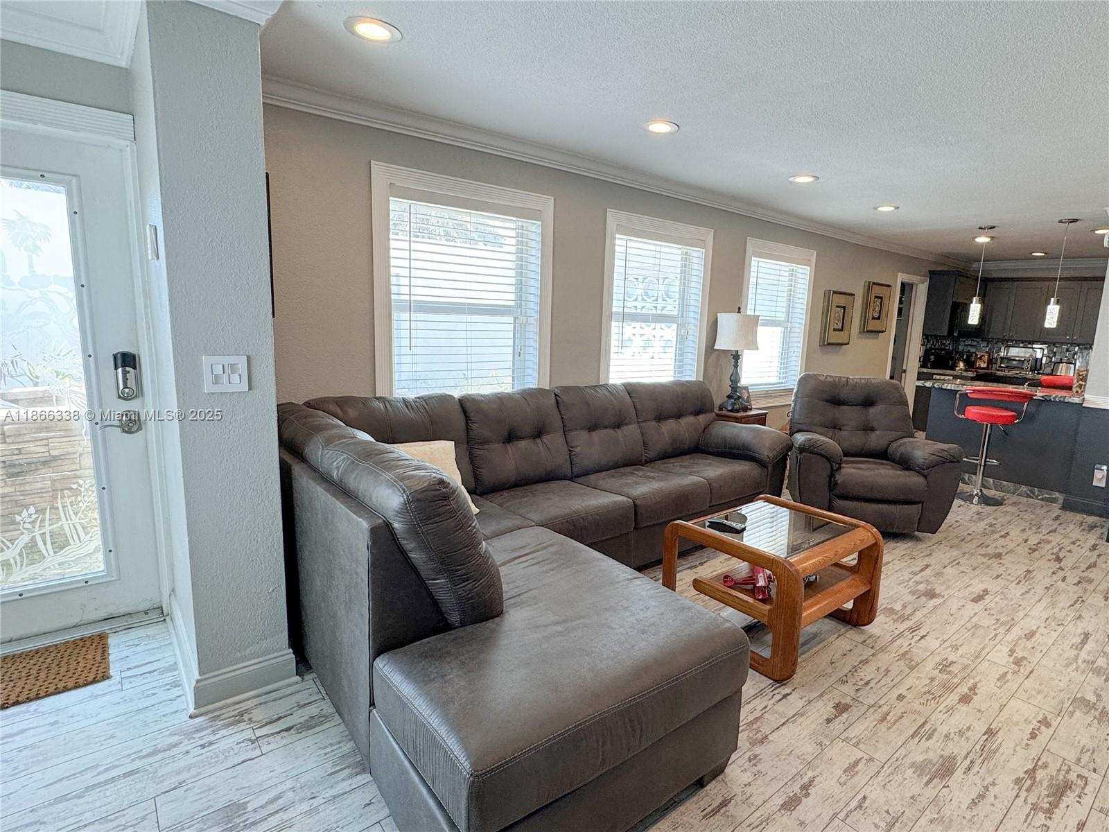161 Northwest 27th Court Pompano Beach, FL 33064 - Photo 5 of 33 a living room with furniture window and wooden floor