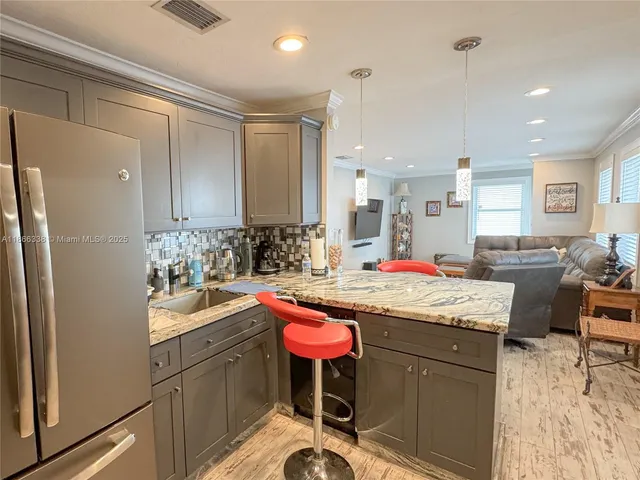 a kitchen with stainless steel appliances a stove a sink and a microwave