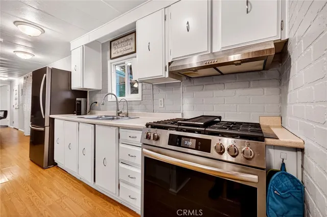 a kitchen with stainless steel appliances granite countertop a stove and a refrigerator