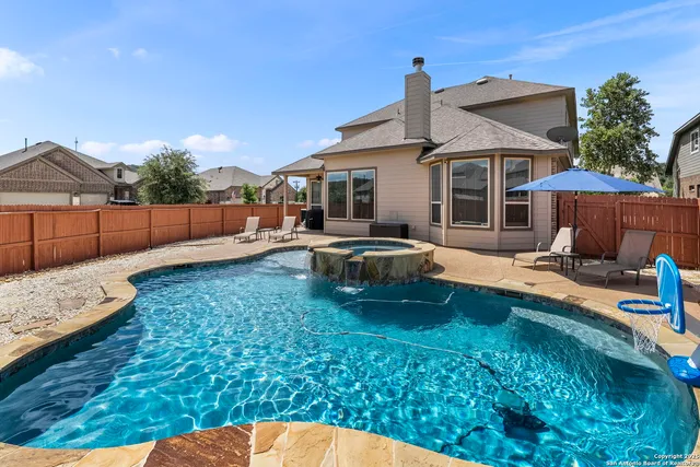 a view of a house with backyard porch and sitting area