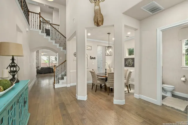 a view of a hallway with wooden floor windows and a livingroom