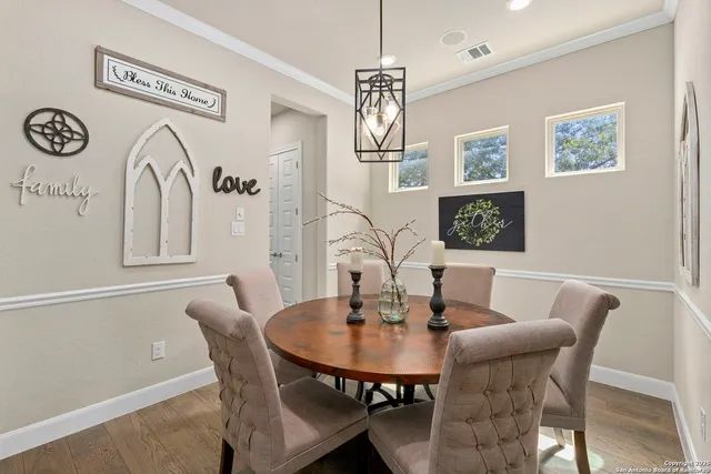 a view of a dining room with furniture and chandelier