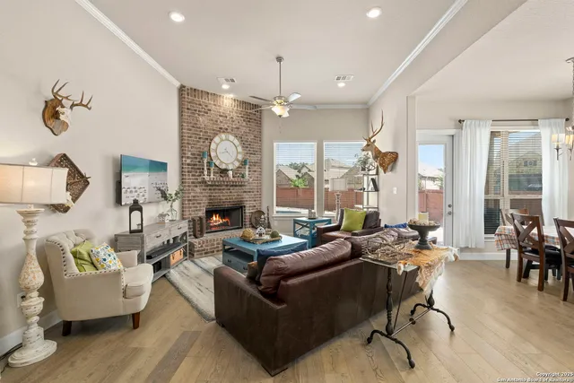 a living room with fireplace furniture and a chandelier