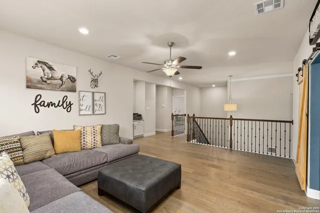 a living room with furniture and a wooden floor