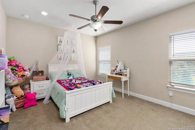 a bedroom with furniture and a window