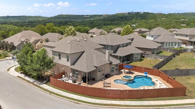 an aerial view of a house with outdoor space and lake view