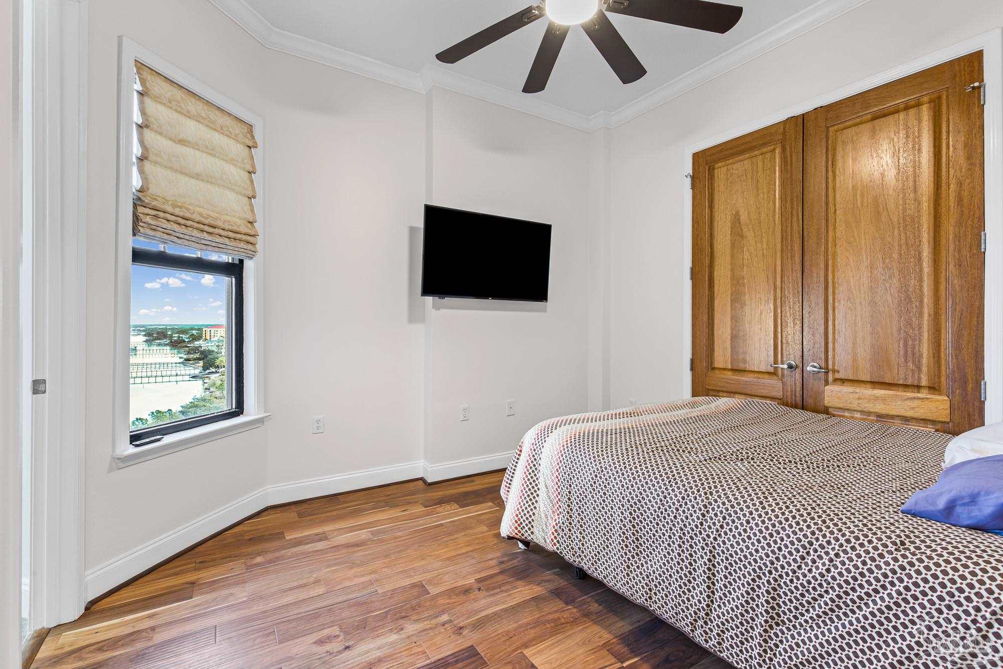 14900 River Road, Unit 904 Perdido Key, FL 32507 - Photo 17 of 62 a bedroom with a bed and a flat tv screen