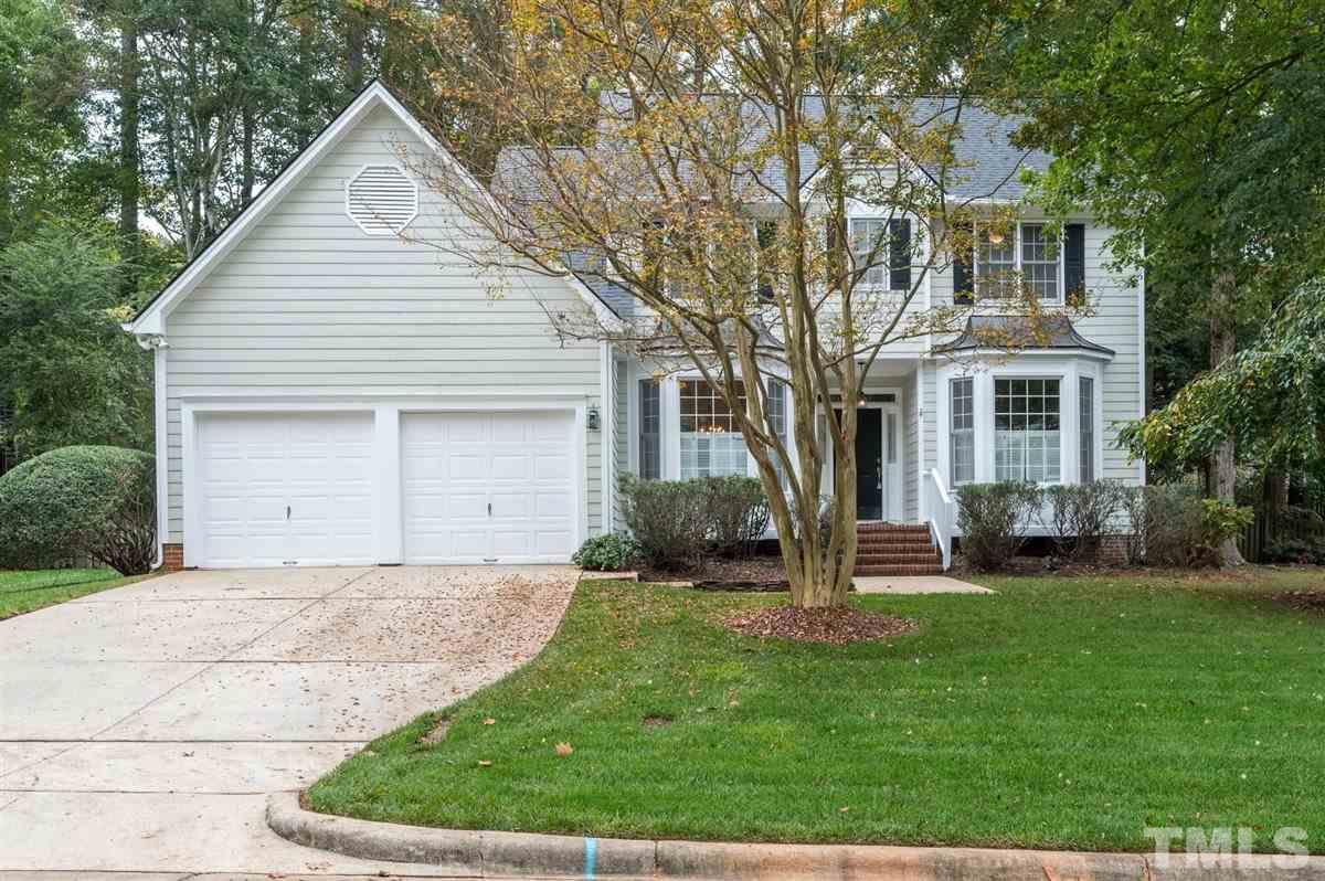5617 Barham Court Raleigh, NC 27613 - Photo 1 of 30 a front view of a house with a yard and garage