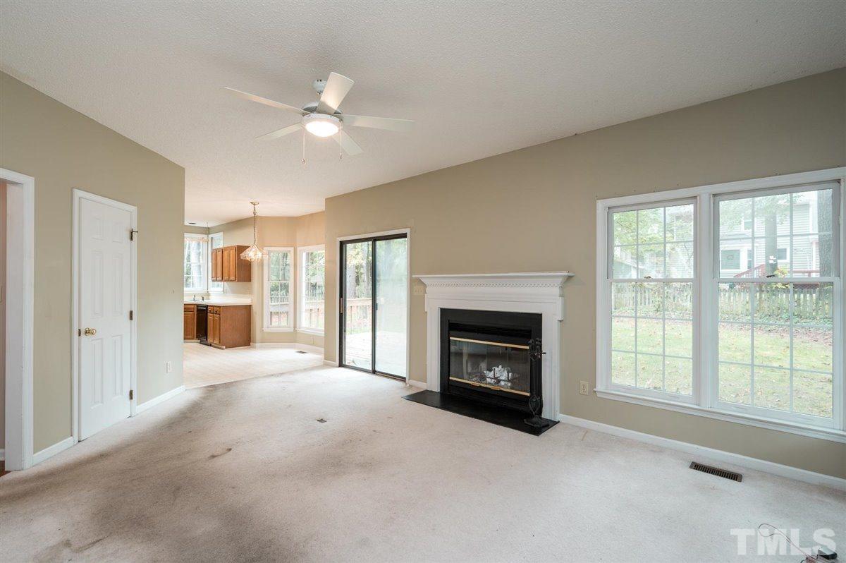 5617 Barham Court Raleigh, NC 27613 - Photo 14 of 30 a view of a livingroom with a fireplace and a window