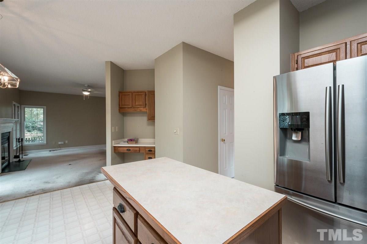 5617 Barham Court Raleigh, NC 27613 - Photo 18 of 30 a kitchen with a refrigerator a sink and a large window