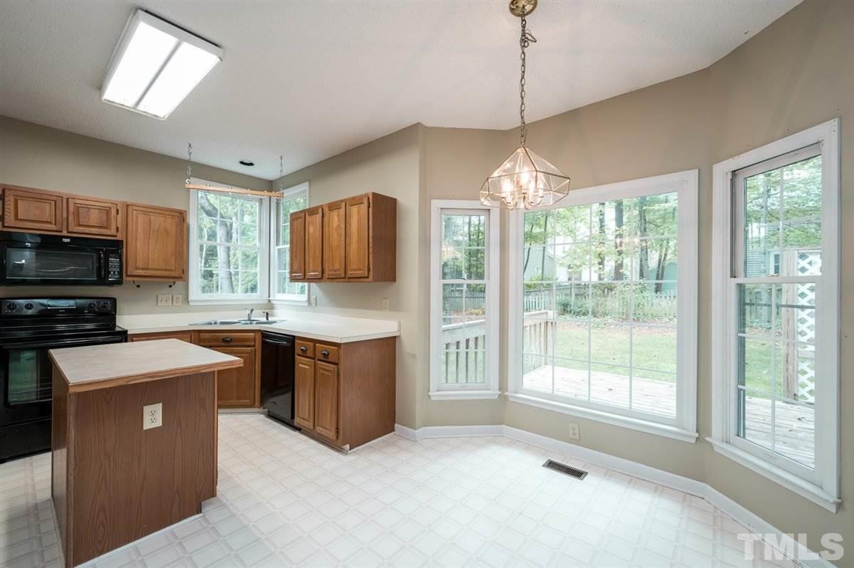 5617 Barham Court Raleigh, NC 27613 - Photo 20 of 30 a kitchen with stainless steel appliances granite countertop a stove top oven a sink dishwasher a refrigerator and a microwave