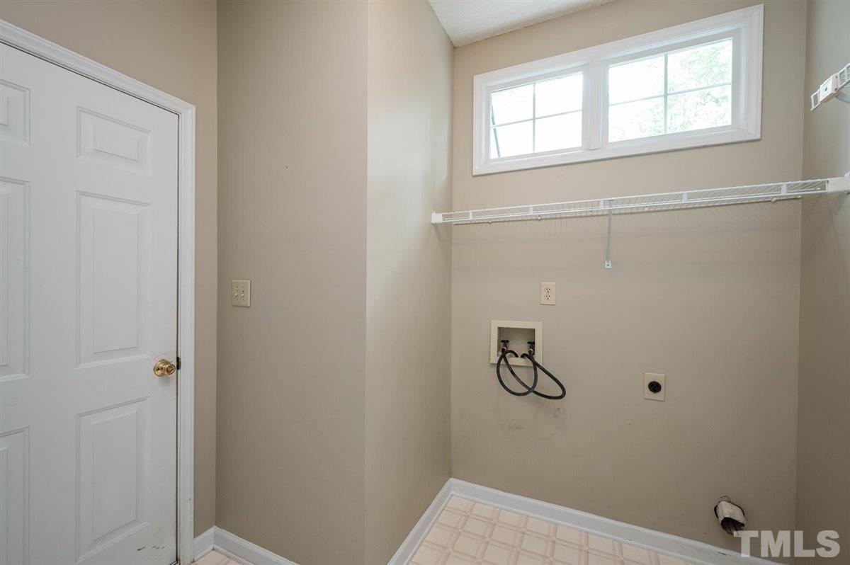 5617 Barham Court Raleigh, NC 27613 - Photo 21 of 30 a bathroom with a bathtub
