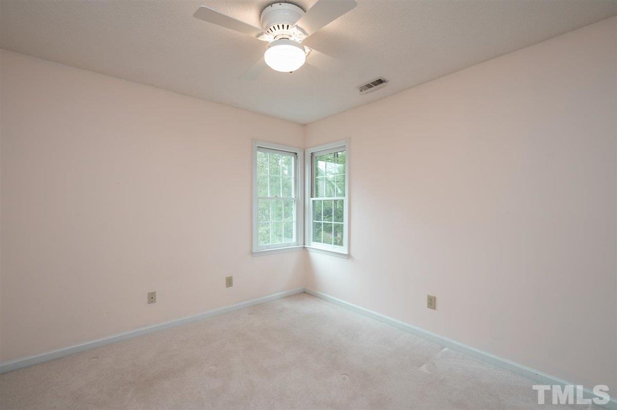 5617 Barham Court Raleigh, NC 27613 - Photo 28 of 30 an empty room with a window and a fan