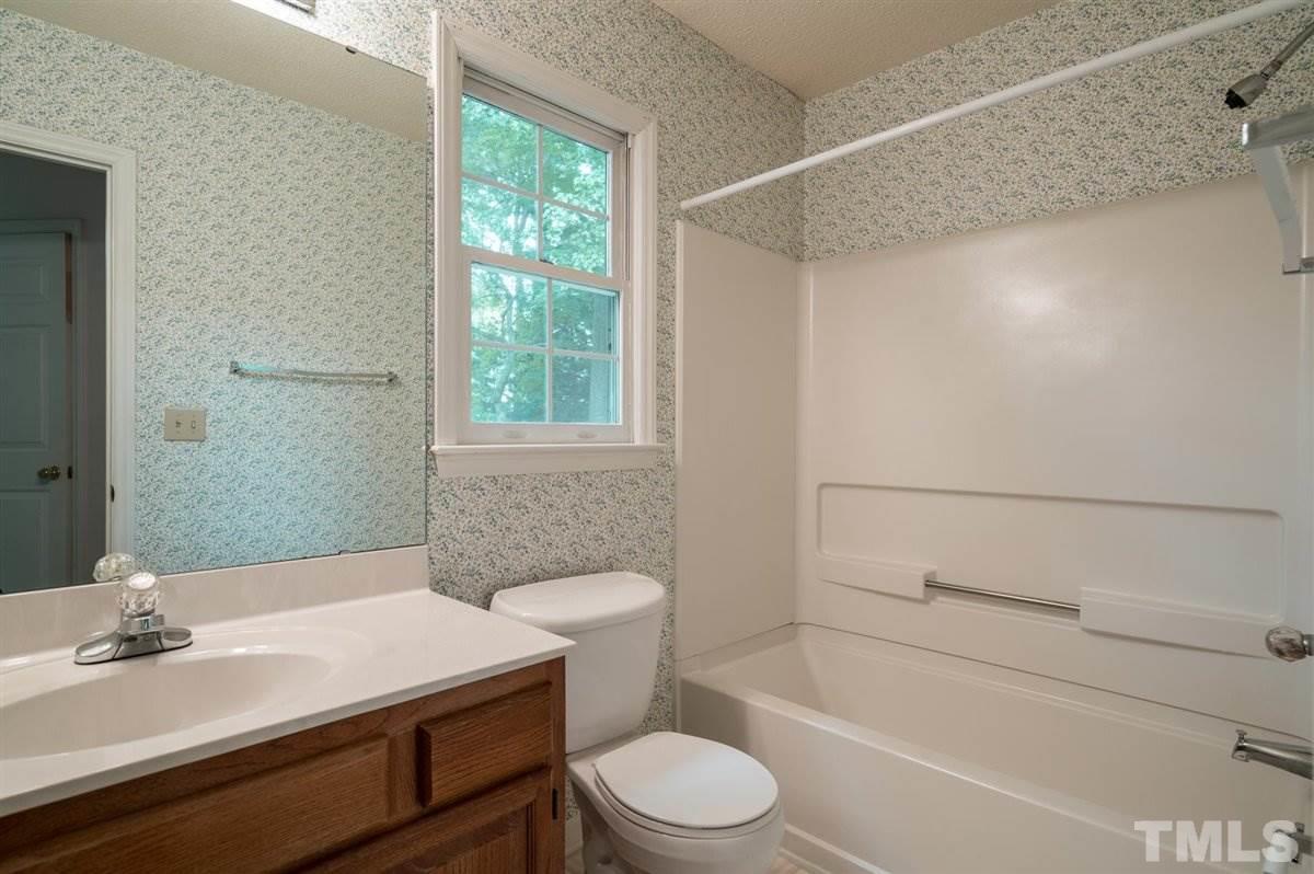 5617 Barham Court Raleigh, NC 27613 - Photo 29 of 30 a bathroom with a sink toilet and shower
