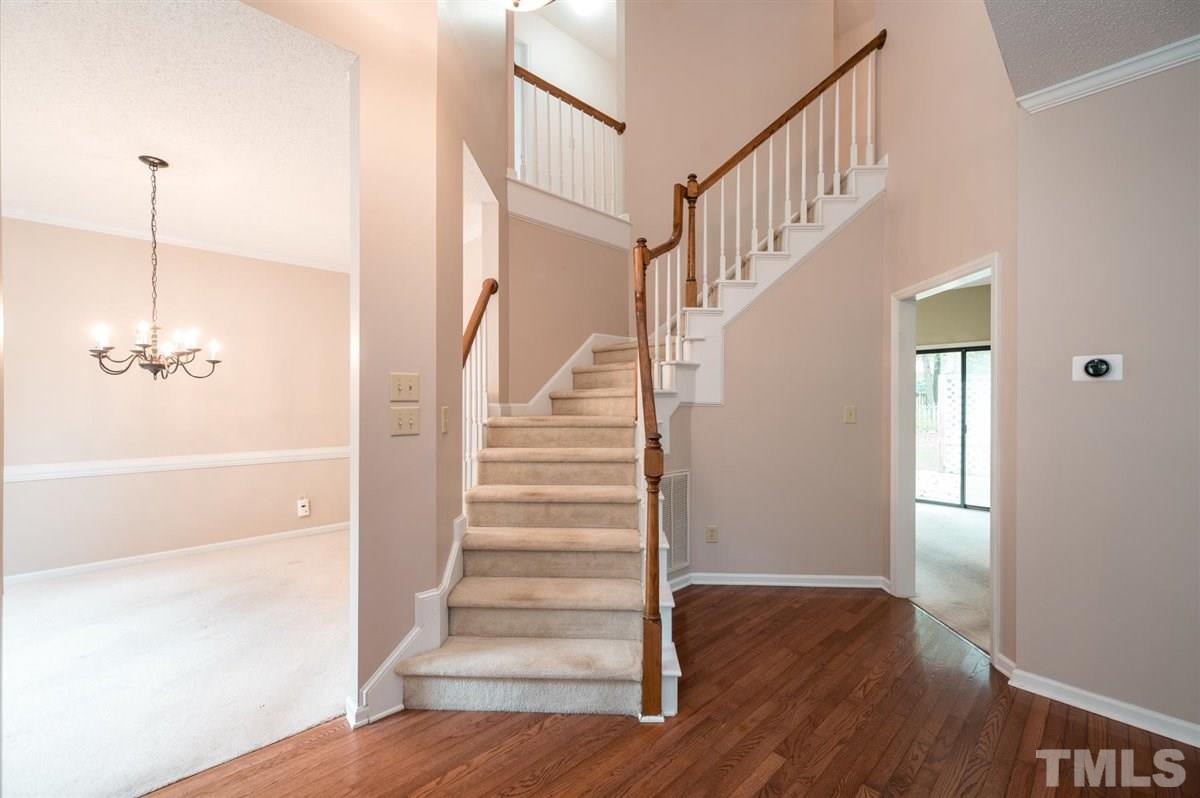 5617 Barham Court Raleigh, NC 27613 - Photo 6 of 30 a view of a hallway with wooden floor and staircase