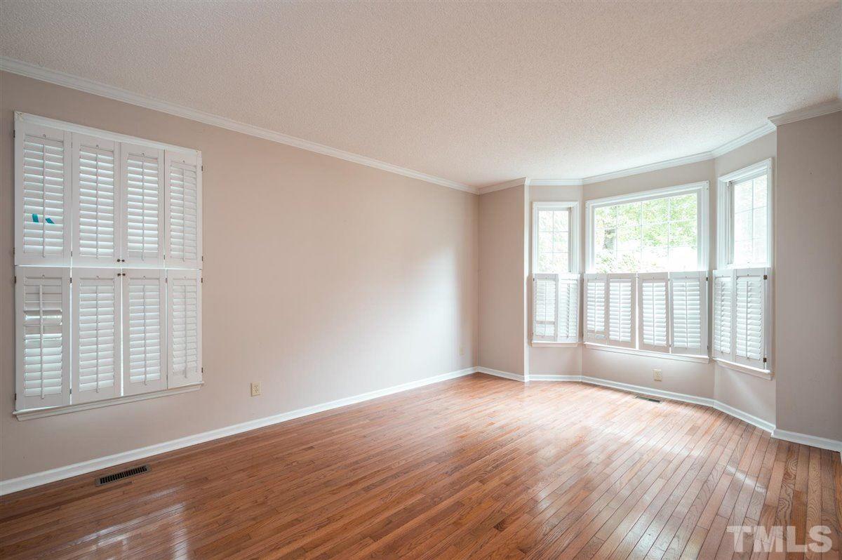 5617 Barham Court Raleigh, NC 27613 - Photo 8 of 30 an empty room with wooden floor and windows