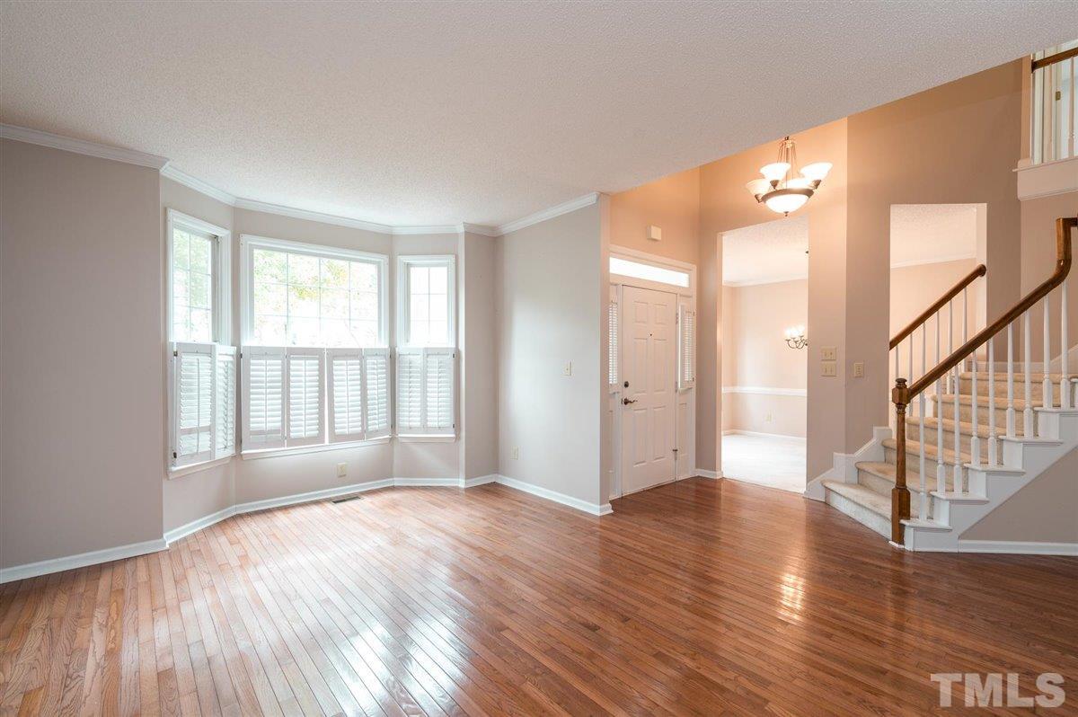 5617 Barham Court Raleigh, NC 27613 - Photo 9 of 30 a view of an empty room with wooden floor and a window