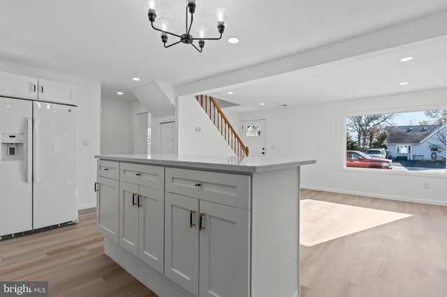 a view of a hallway with cabinet and mirrors