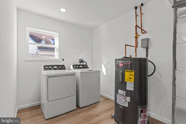 a view of storage and utility room with washer and dryer