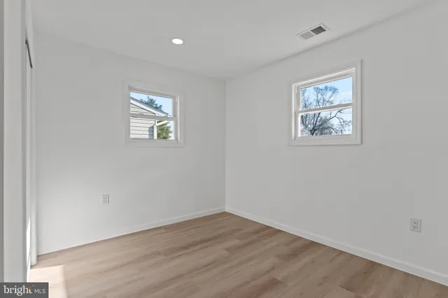 an empty room with a painting on the wall