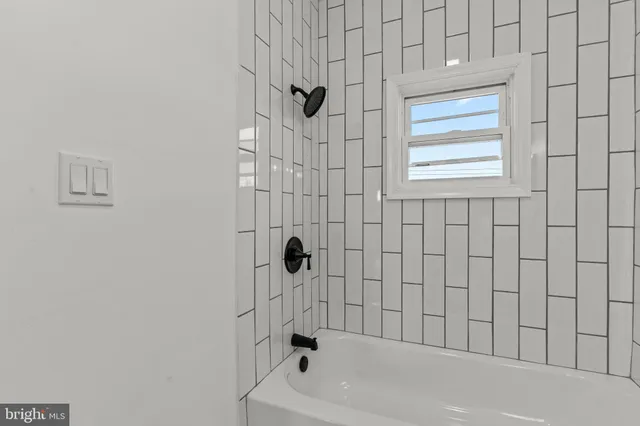 a bathroom with a bathtub and shower