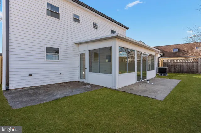 a view of house with backyard and porch