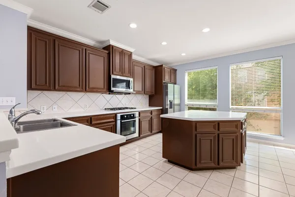 a kitchen with a stove sink and microwave