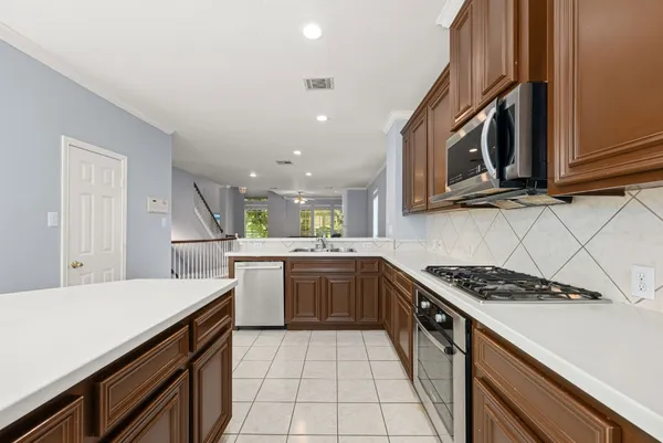 a kitchen with a sink a stove and cabinets