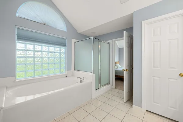 a bathroom with a bathtub and a shower