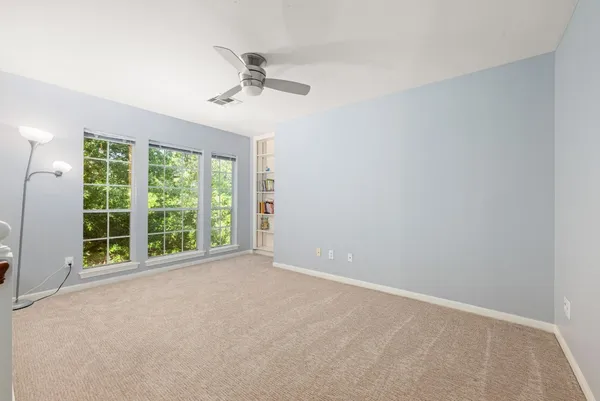 a view of a livingroom with a ceiling fan and window
