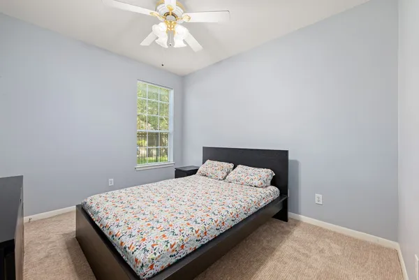 a bedroom with a bed and window