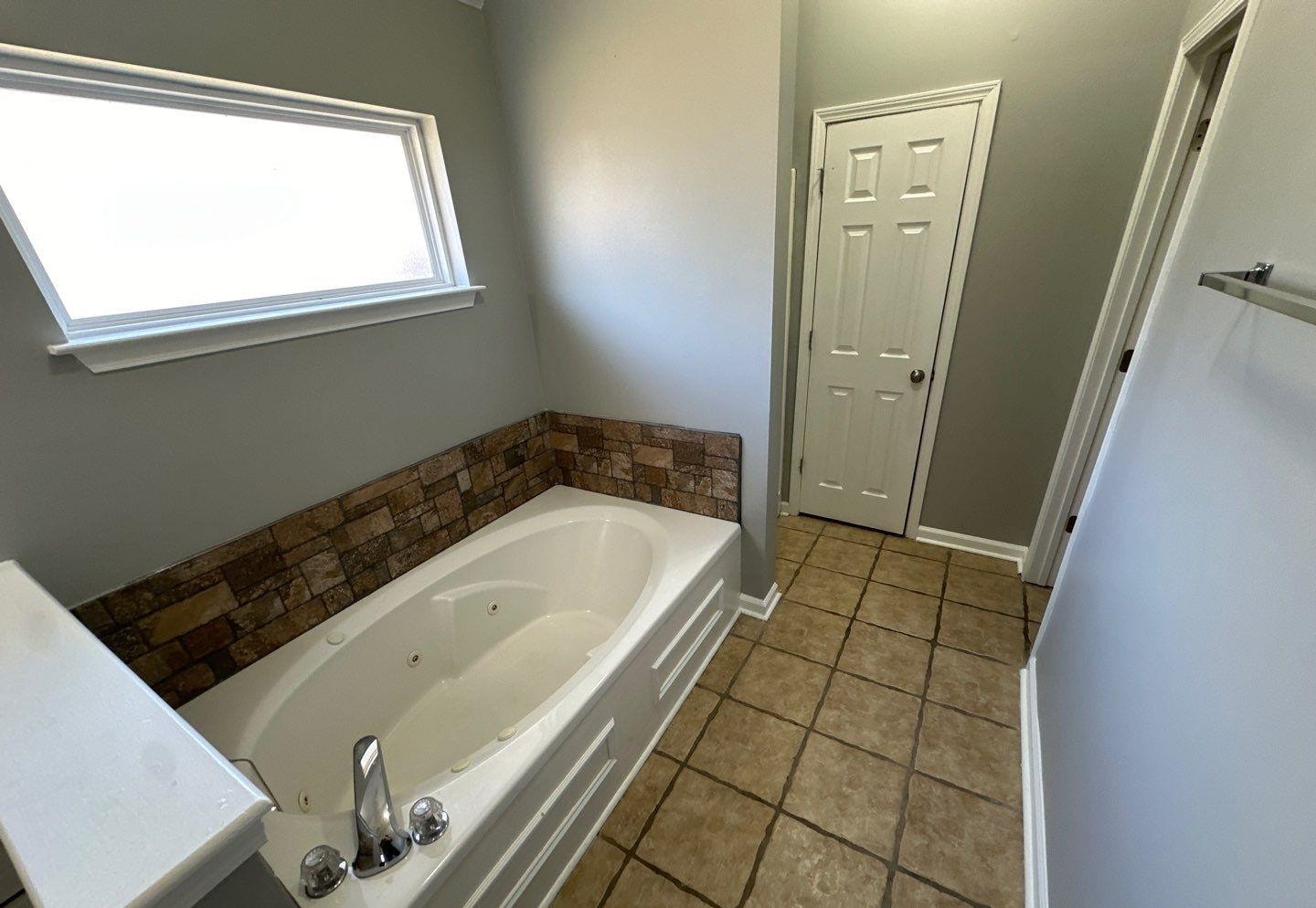 9420 Grove Road Cordova, TN 38016 - Photo 13 of 15 Bathroom featuring a whirlpool tub and tile patterned flooring